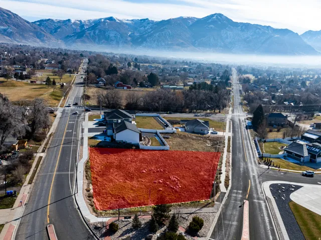 Expansive lot with direct road frontage, sidewalk access, and mountain scenery