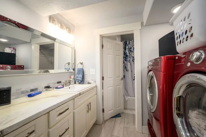 Vanity with an integrated sink, polished chrome faucet, and a stone-finish countertop