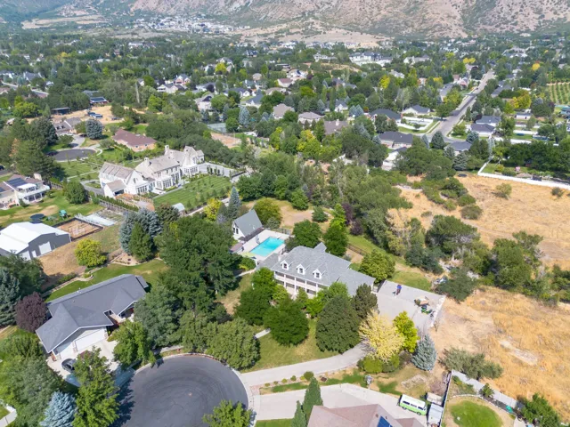 Expansive property with a large residence, detached garage, and a swimming pool