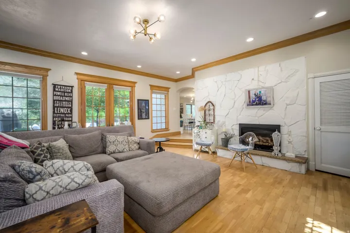 White stone fireplace with a black firebox and a stone hearth