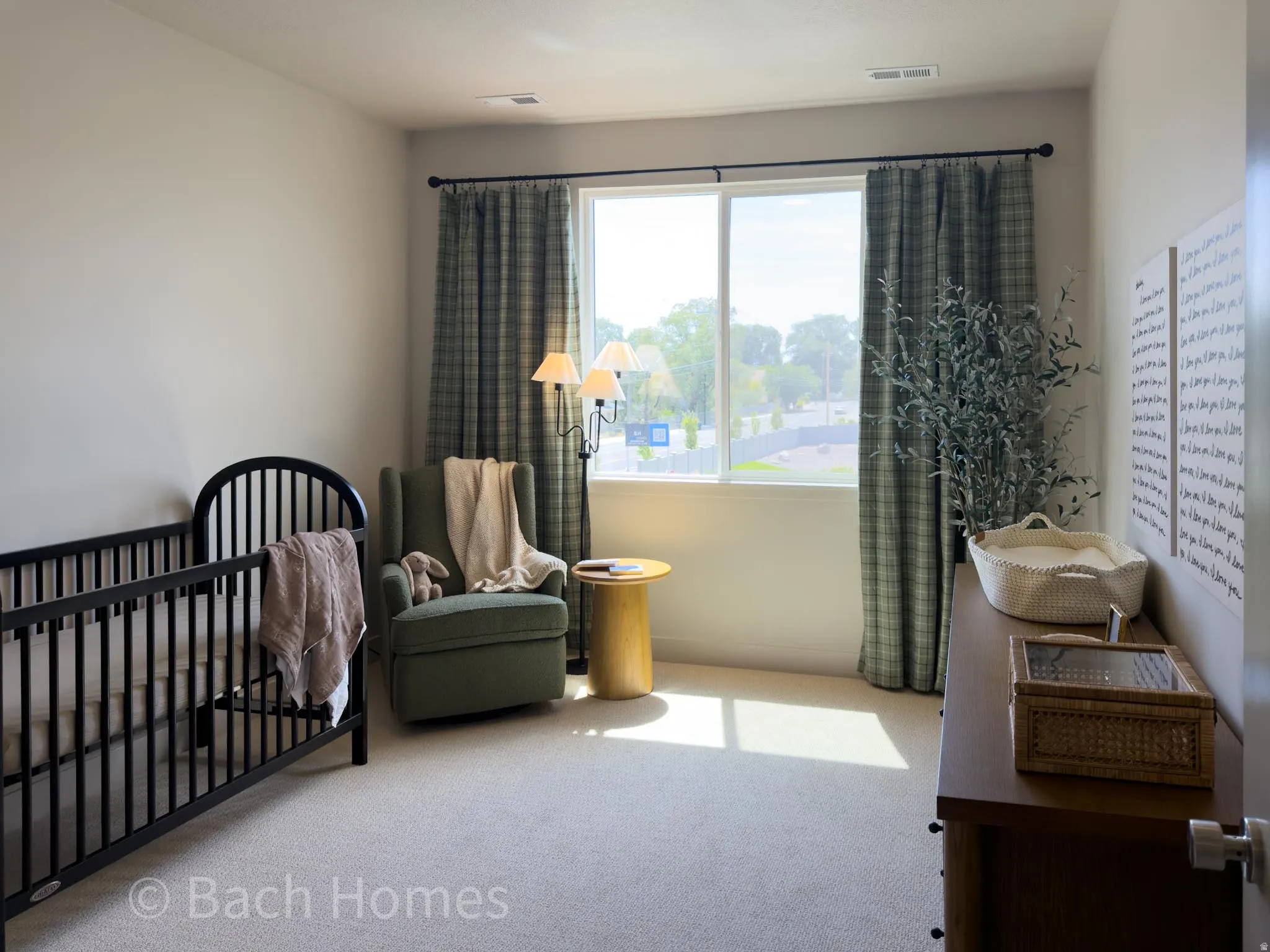 Neutral wall paint, carpet flooring, a large window, and wall-mounted light fixtures