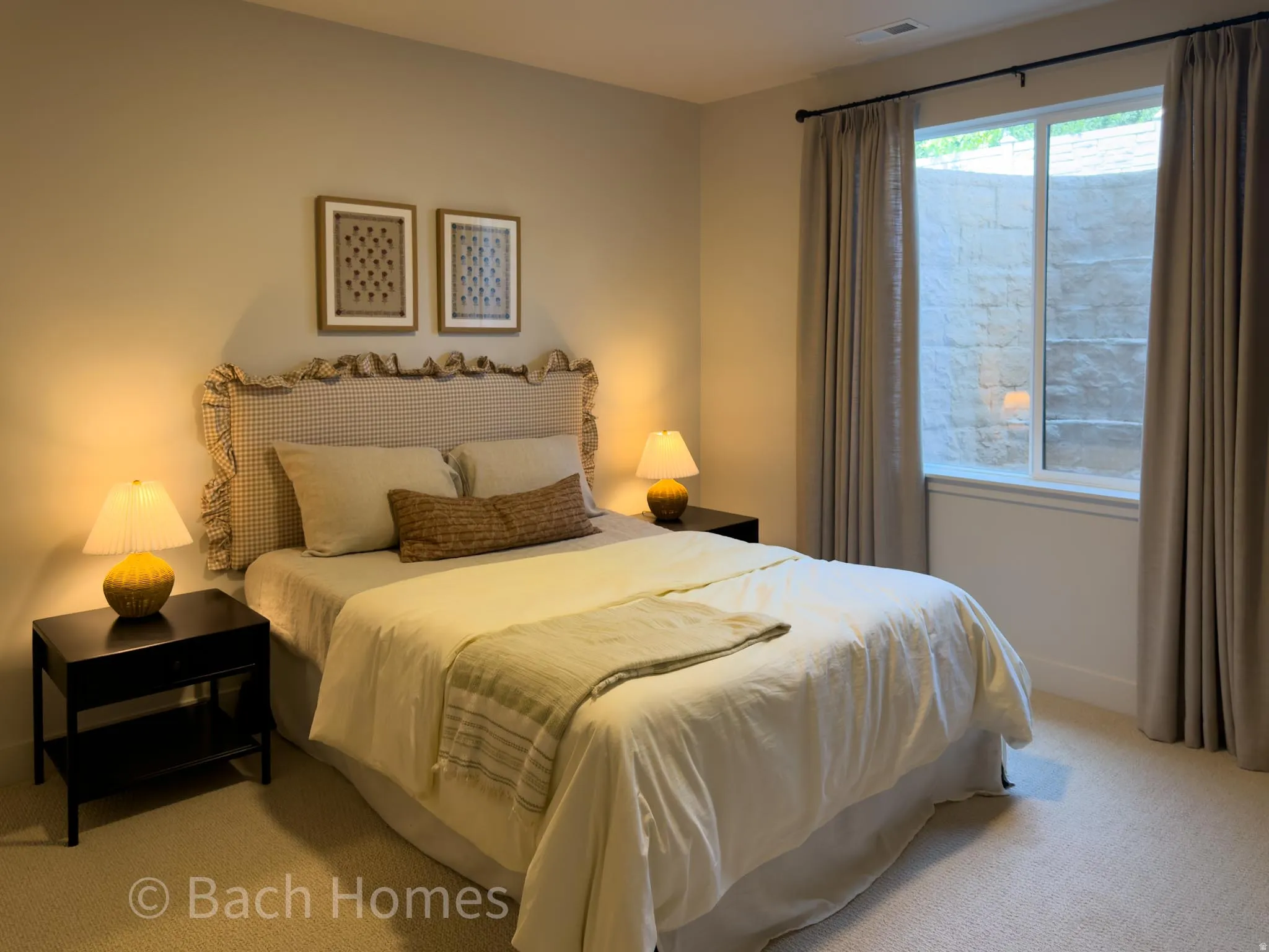 Neutral wall color with recessed lighting, carpeted flooring, and a large window with privacy curtains