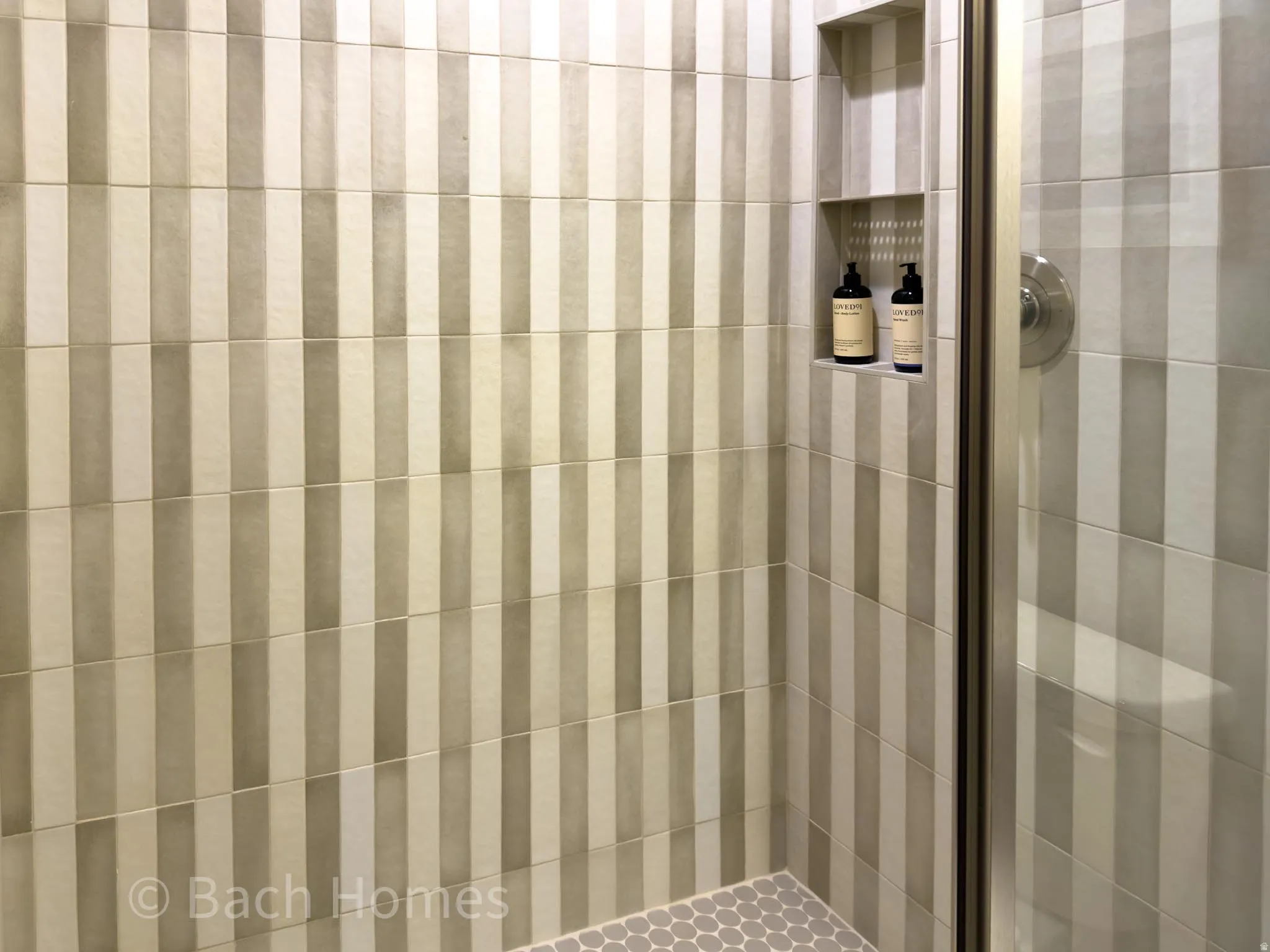 Tiled shower enclosure with vertical striped wall tiles