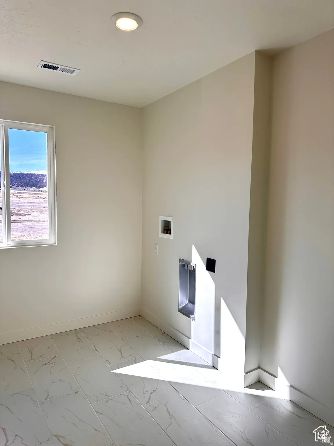 Recessed ceiling lighting, tiled flooring, window with exterior scenery, and laundry hookups