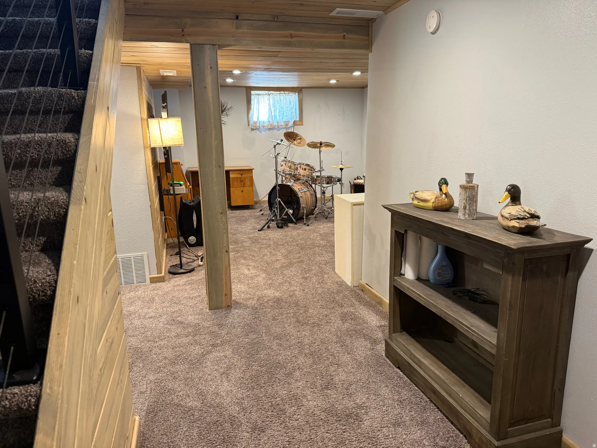 Finished basement featuring open-concept layout with wood-finish flooring, recessed lighting, and support columns