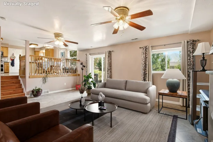 Expansive living area with high ceilings, recessed lighting, and dual ceiling fans