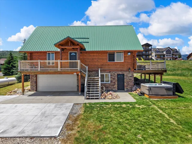 Log-sided exterior with a green metal roof
