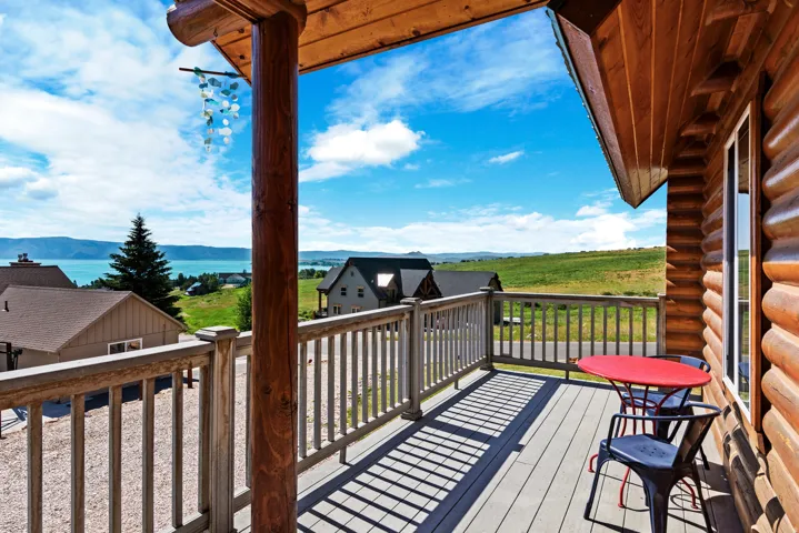 Expansive outdoor deck with a wood railing and a wood-finish exterior wall