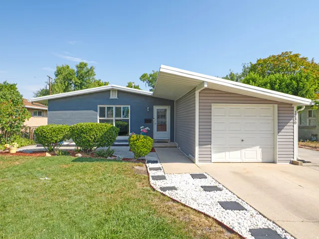 Contemporary single-story home featuring a clean-lined exterior with blue-gray siding and white trim accents