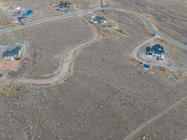 Aerial Survey. Depicting the property layout with residential structures, road infrastructure, and surrounding land parcels