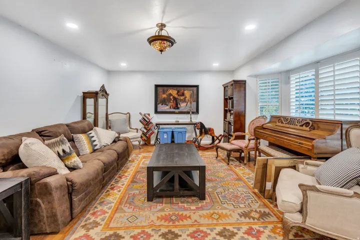 Recessed lighting, wood-finish flooring, and crown molding