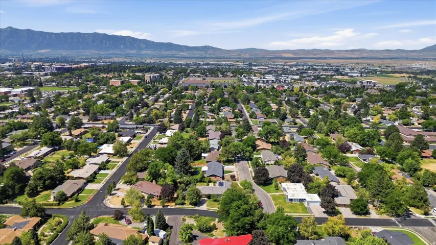 Aerial perspective showcasing this established residential neighborhood featuring mature tree-lined streets, single-family homes on generous lots, and manicured landscaping