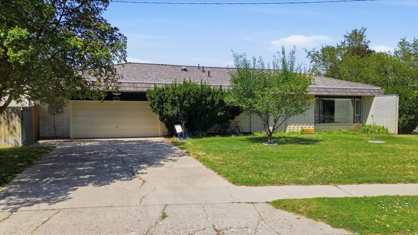 Charming single-story home with an attached two-car garage and expansive front driveway