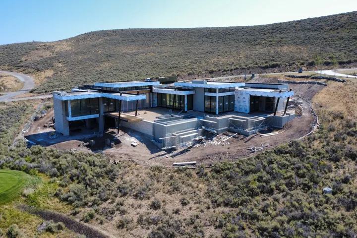 Modern architectural design with extensive glass paneling, flat rooflines, and a tiered exterior structure