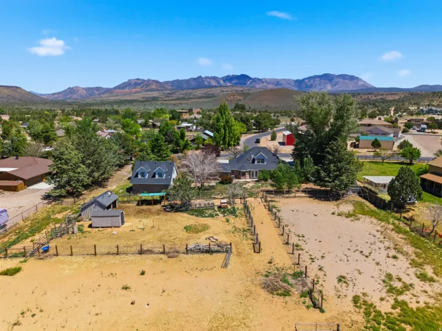 Expansive property featuring multiple structures, open land, and perimeter fencing