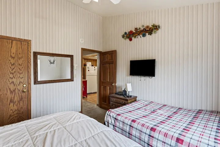 Textured wall covering, wood-finish doors, and mounted television