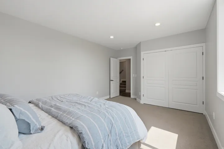 Plush carpet flooring, recessed lighting, and a window