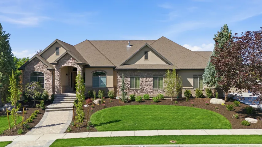 Stone and stucco exterior with multiple gables