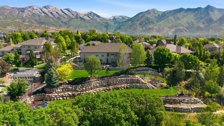 Expansive residential lot showcasing mature landscaping, manicured lawn, and established trees throughout the property
