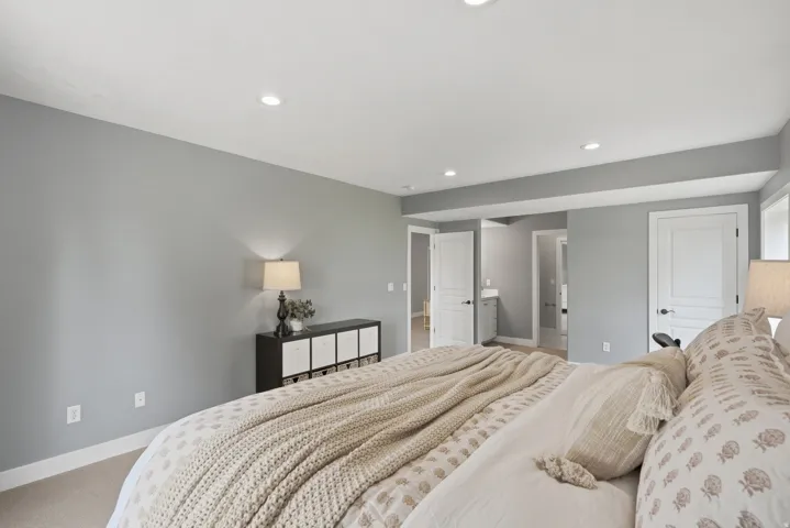 Recessed ceiling lighting, light gray wall paint, and white trim accents throughout