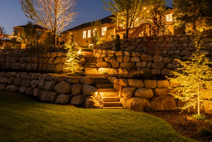 Tiered stone retaining walls with integrated landscape lighting