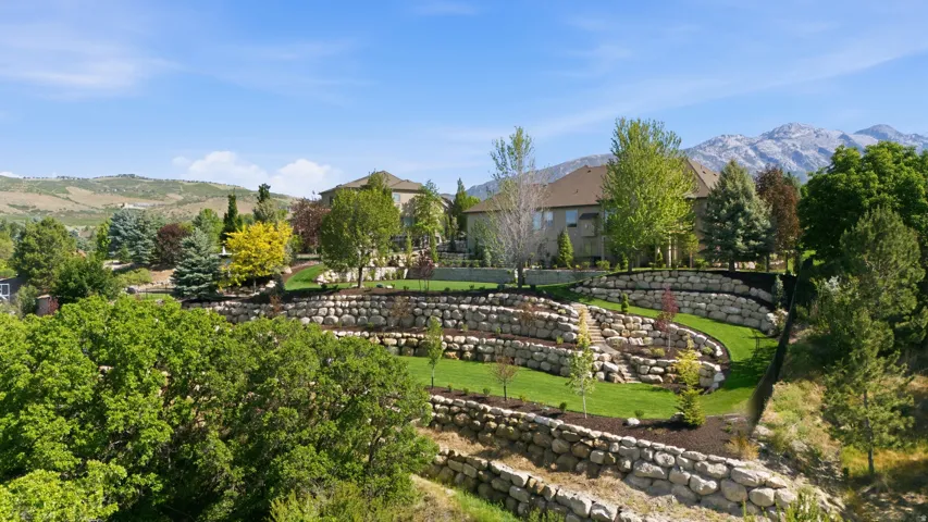 Terraced stone hardscaping with multiple tiered levels creates distinctive architectural interest throughout the grounds