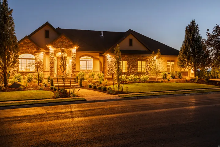 Stone and stucco exterior with multiple gables and dormers