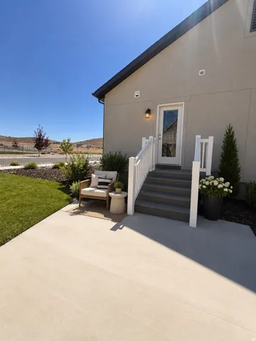 Patio with concrete surface, direct exterior access, and a manicured lawn