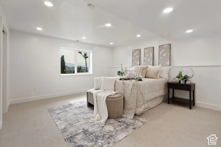 Recessed lighting, wall-to-wall carpeting, and a window with mountain and tree scenery