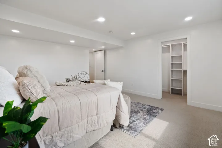 Primary Bedroom Suite with Recessed Ceiling Lighting, Neutral Carpet Flooring, and Dual Built-In Closet Systems with Shelving