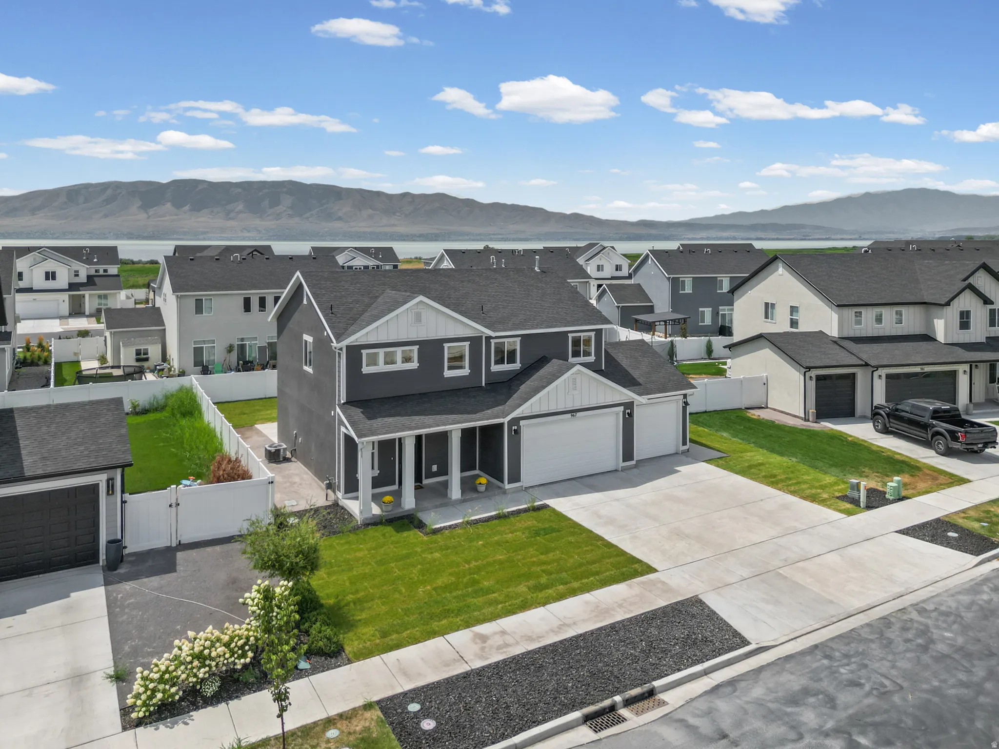 Two-story residence with a dark gray exterior, white trim, and a two-car garage