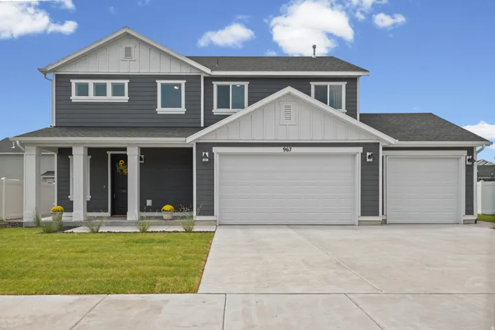 Two-story residence featuring a dark gray siding exterior with white trim accents