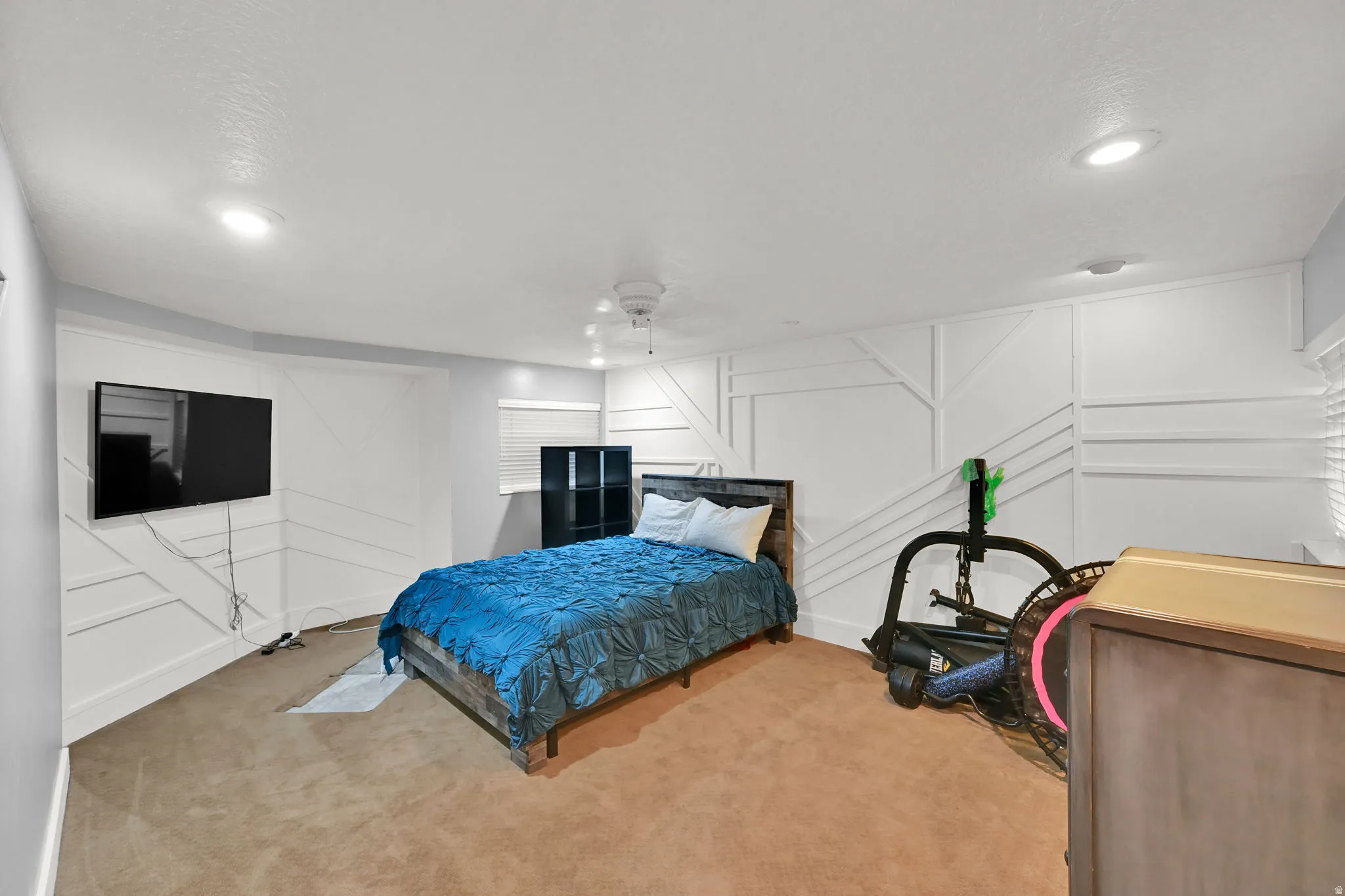 Finished Basement Recreation Room featuring recessed ceiling lighting, wall-mounted flat-screen television, carpeted flooring, and ample space for multiple uses