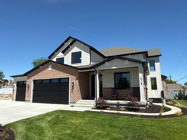 Contemporary two-story residence featuring a brick and siding exterior