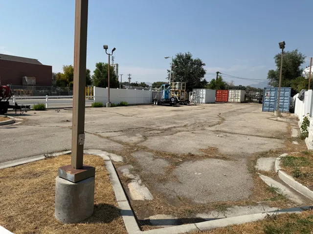 Paved lot with perimeter fencing and exterior lighting