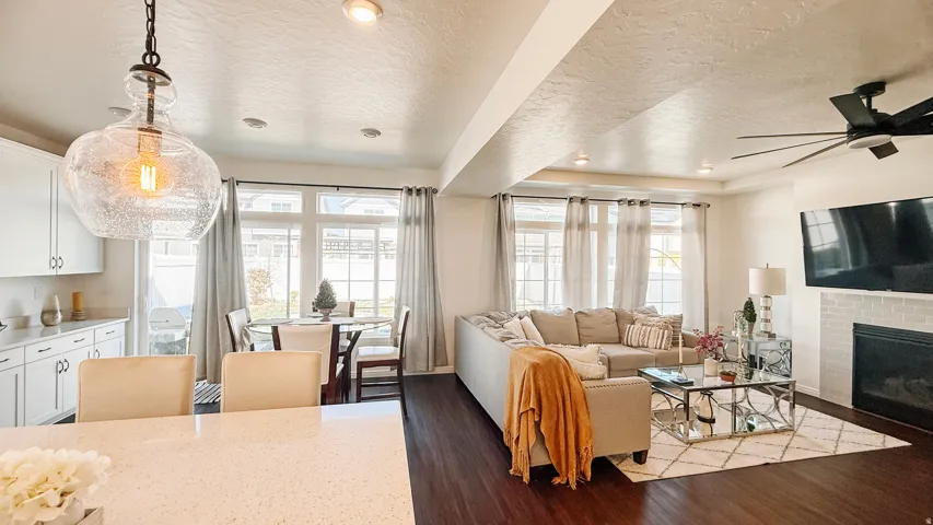 Dark wood-finish flooring, recessed lighting, and a modern ceiling fan