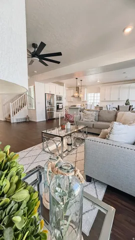 Open-concept living space featuring wood-finish flooring, a modern ceiling fan, and recessed lighting