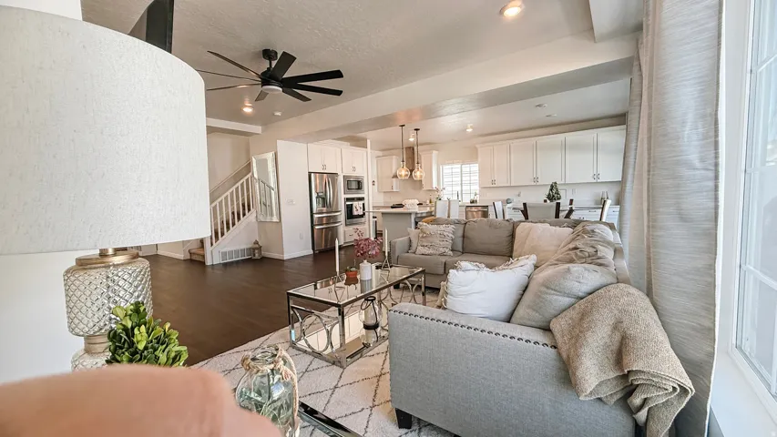 Open-concept living space featuring wood-finish flooring, recessed lighting, and a ceiling fan