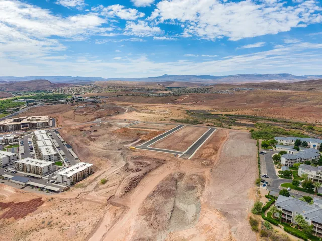 Expansive land parcels prepared for development, featuring graded terrain and newly paved roads