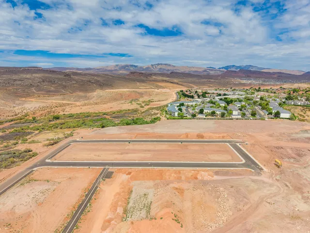 Graded land plots with paved streets and established community elements