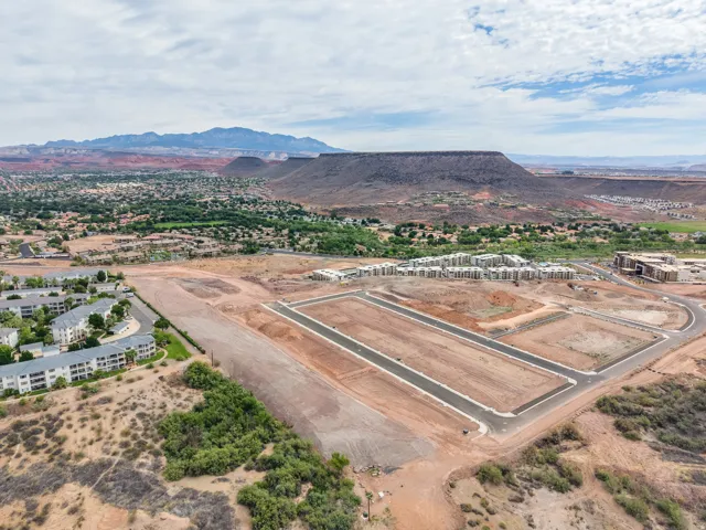 Expansive land parcel featuring new road infrastructure and a mountainous backdrop