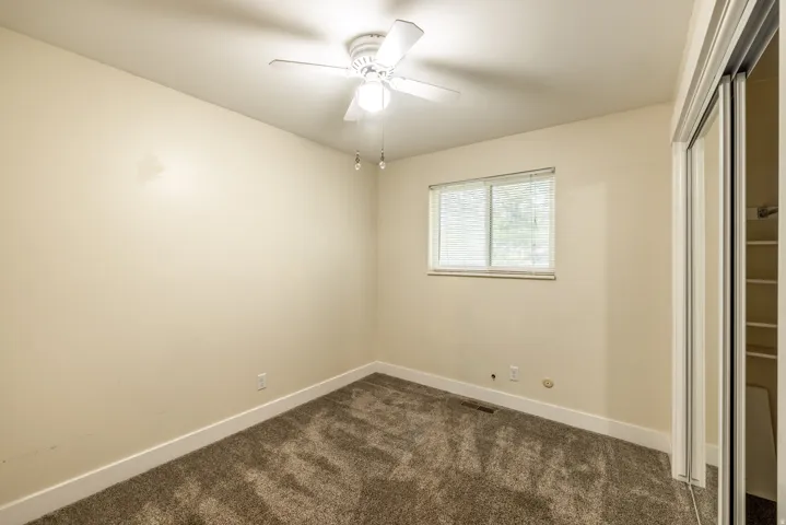 Neutral-toned walls complement plush carpeting