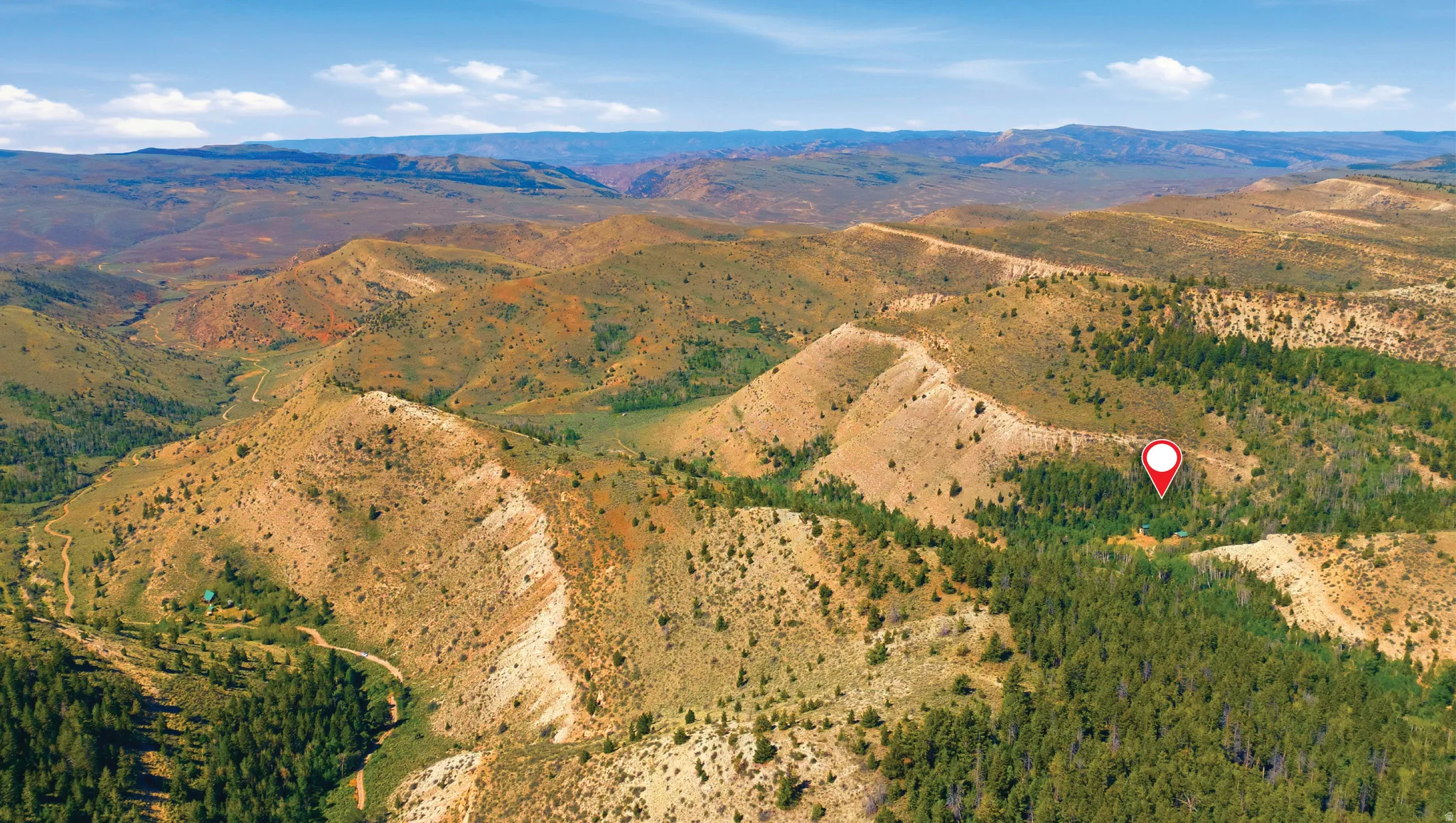 Expansive mountainous terrain featuring varied elevations and natural vegetation