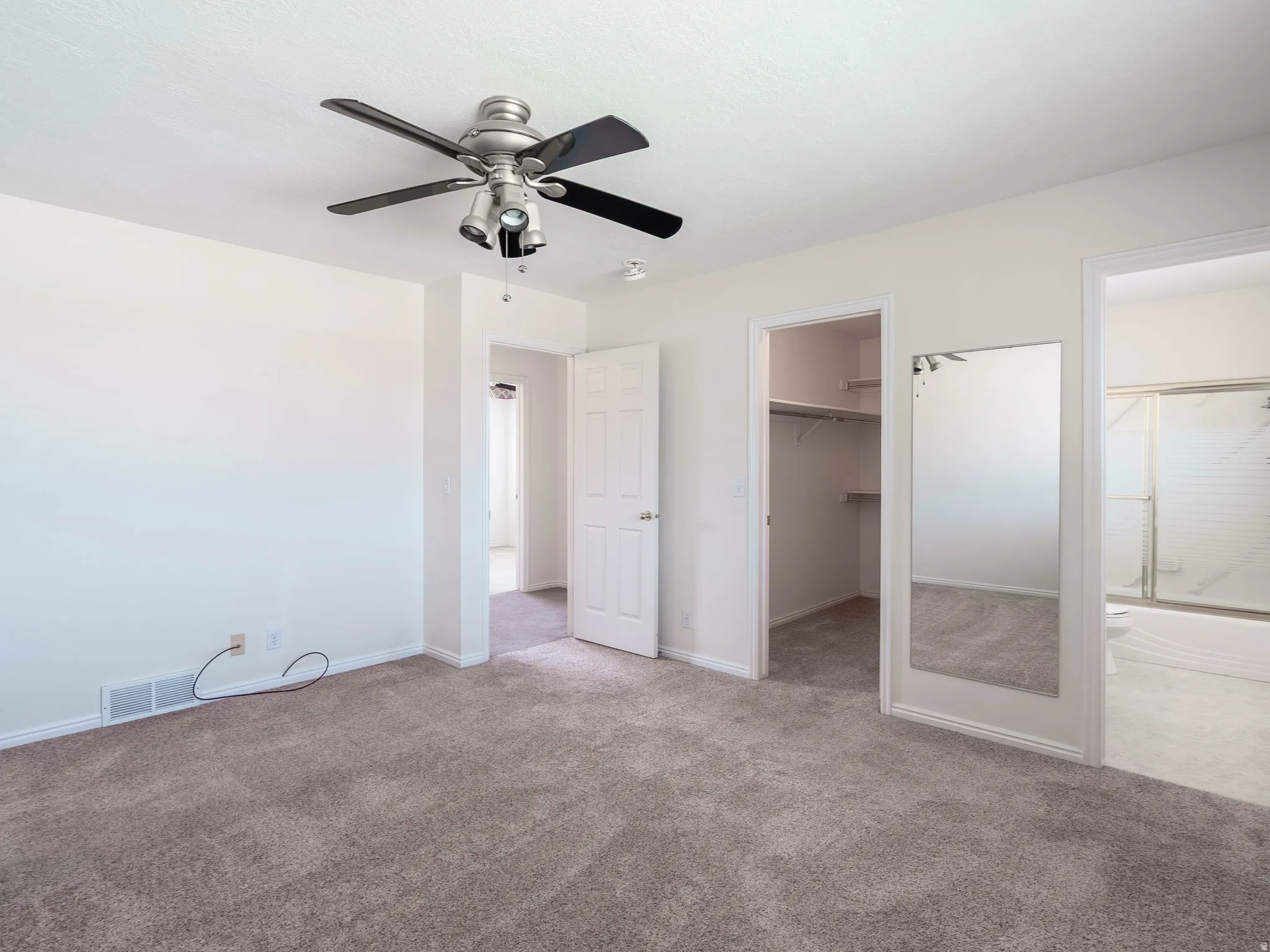 Recessed lighting, ceiling fan, carpeted flooring, built-in closet shelving, and a full-length mirror