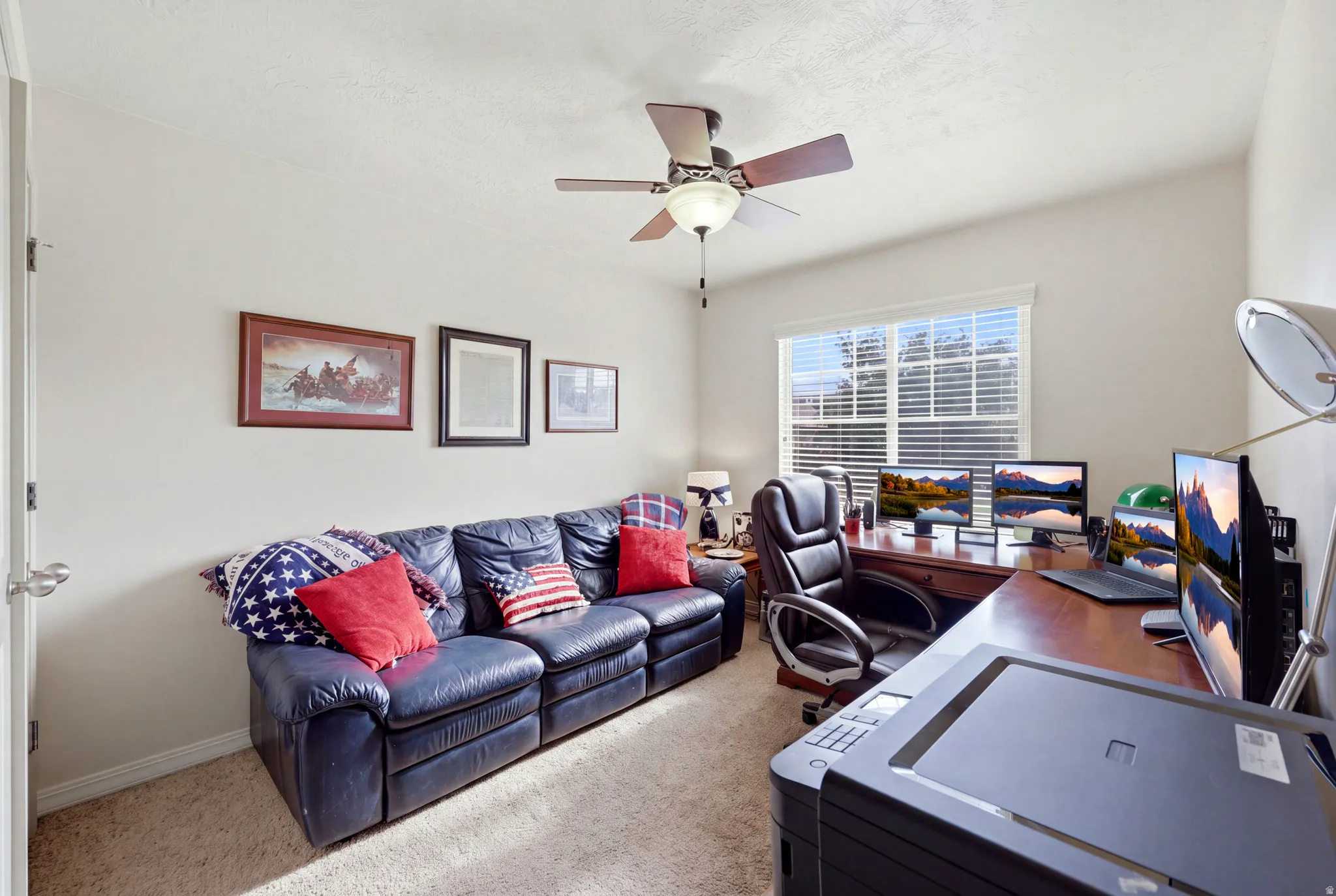 Carpeted room with a ceiling fan, light-colored walls, and a window with horizontal blinds