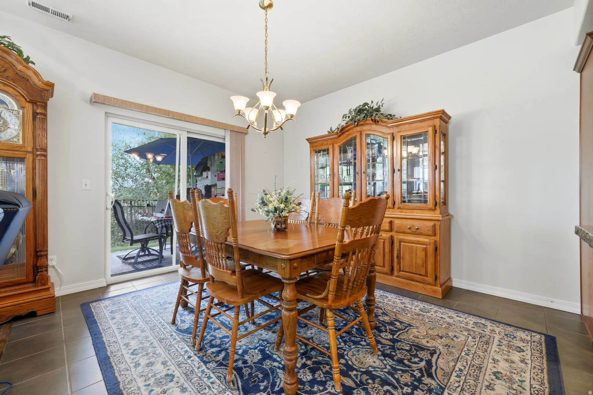 Sliding glass door, recessed lighting, tile flooring, and ceiling-mounted light fixture
