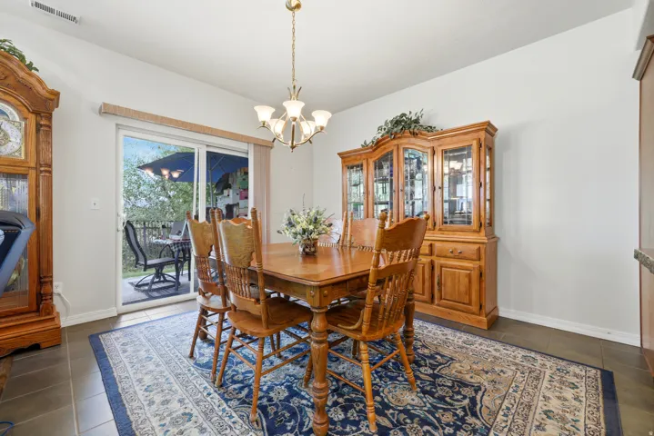 Sliding glass door, recessed lighting, tile flooring, and ceiling-mounted light fixture