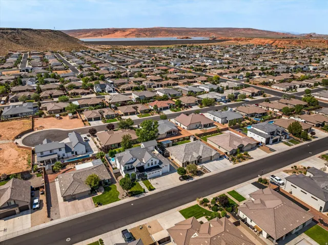 Aerial view of a well-planned residential community featuring single-family homes with individual landscaping, paved streets, and mature trees throughout the neighborhood