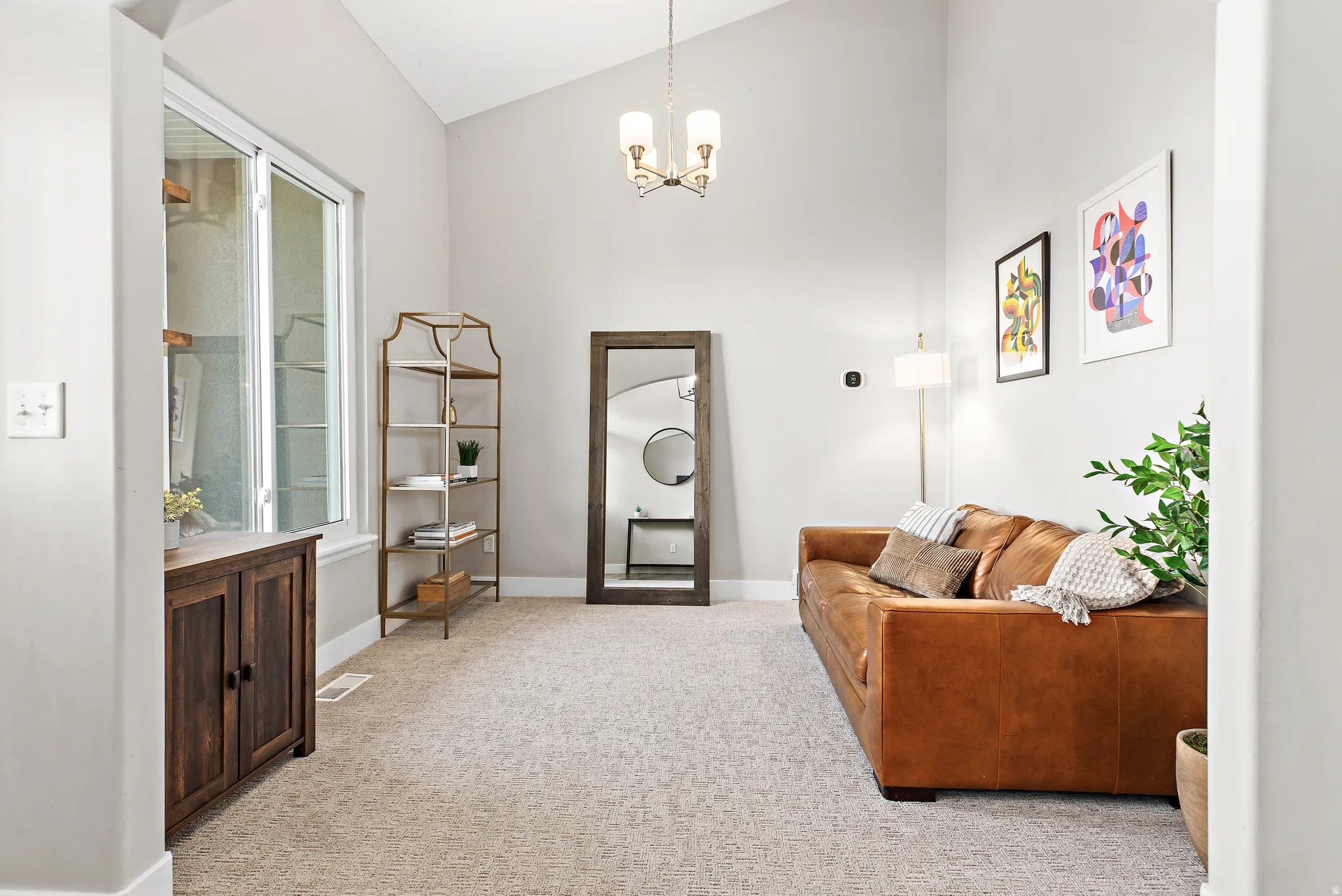 Bright, open foyer featuring soaring vaulted ceilings, recessed lighting, and neutral wall finishes