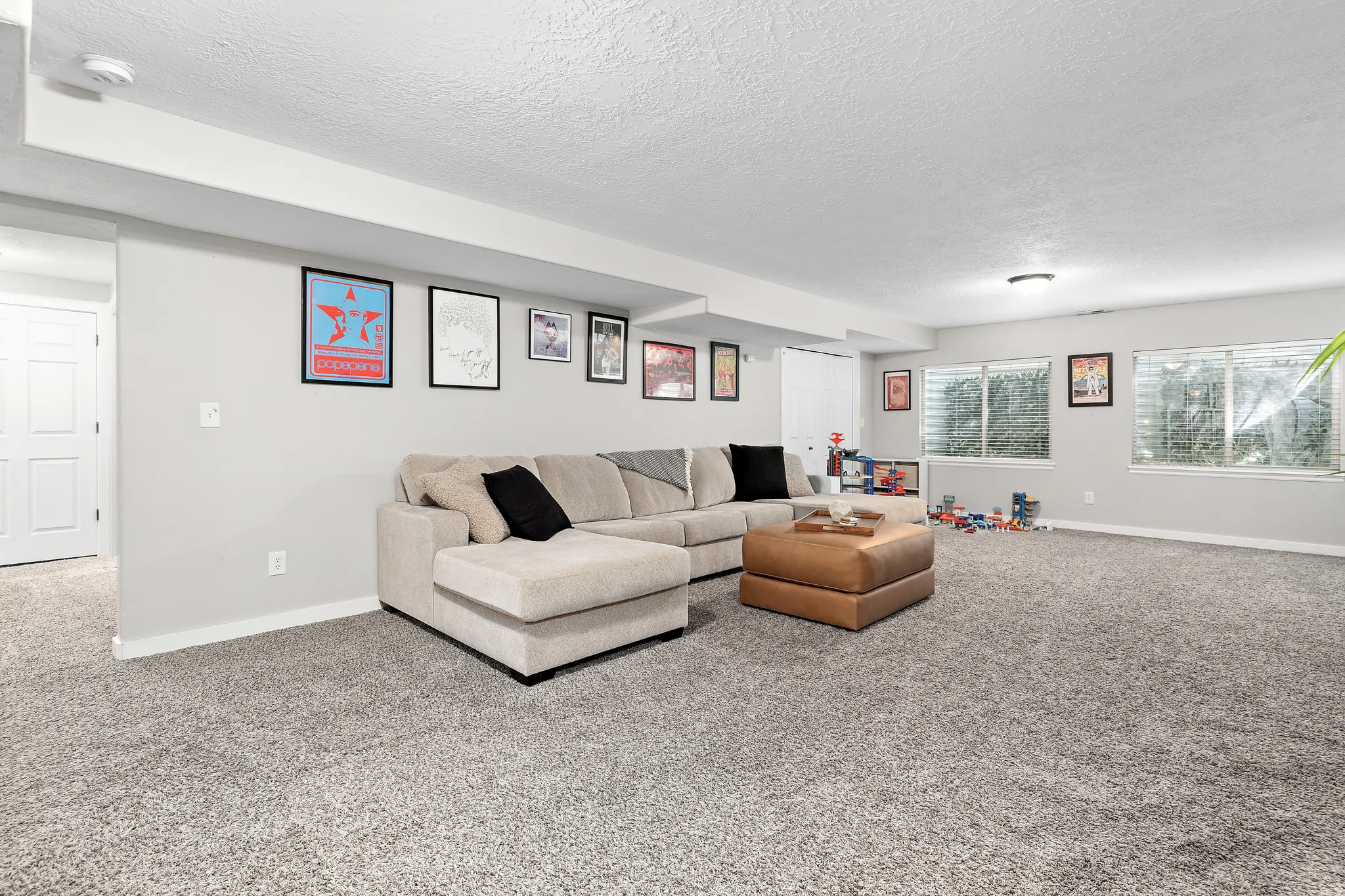Spacious room with gray wall paint and complementary gray carpet flooring